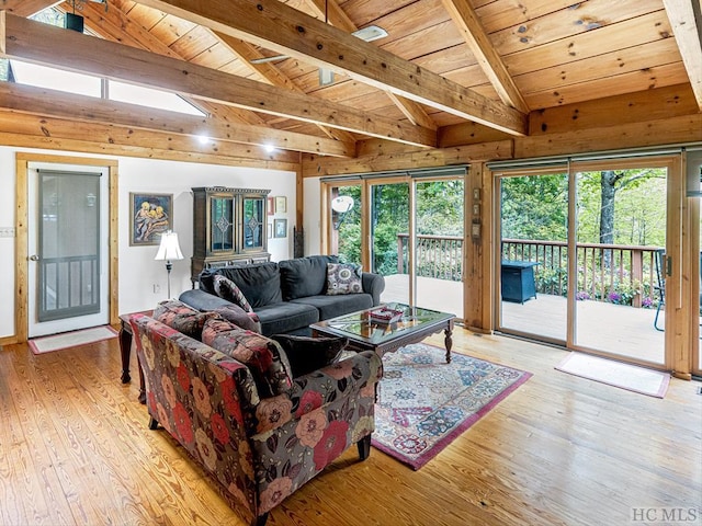 living room with light hardwood / wood-style flooring, vaulted ceiling with beams, and wooden ceiling