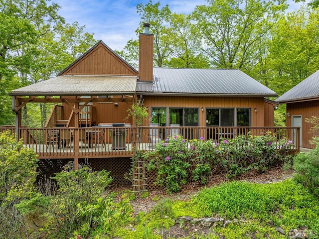 rear view of property featuring a wooden deck