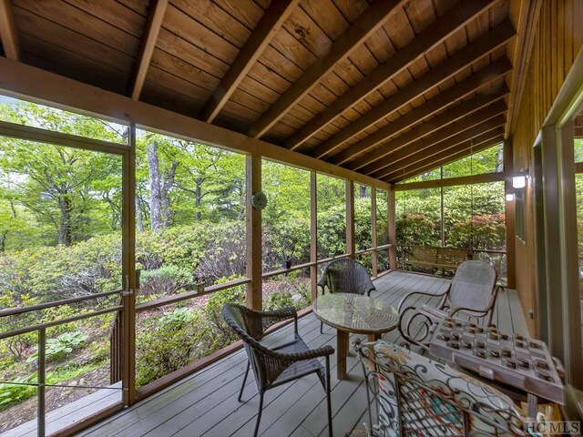 unfurnished sunroom with wooden ceiling and vaulted ceiling with beams