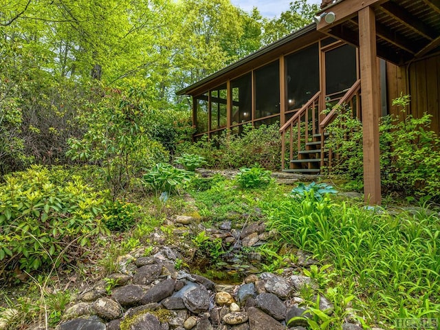 view of yard with a sunroom