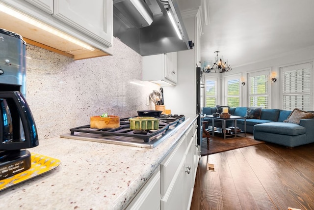 592 Whiteside Mountain Rd, Highlands, NC 28741 - kitchen with range hood, stainless steel gas cooktop, white cabinetry, a chandelier, and tasteful backsplash
