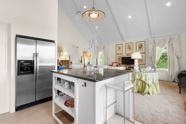 592 Whiteside Mountain Rd, Highlands, NC 28741 - kitchen with stainless steel refrigerator with ice dispenser, beam ceiling, dark stone countertops, open floor plan, and a kitchen island