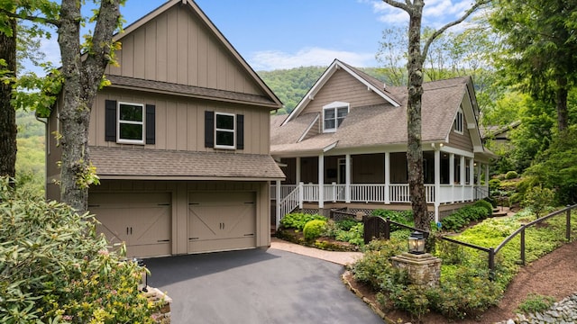 592 Whiteside Mountain Rd, Highlands, NC 28741 - view of front of home with an attached garage, roof with shingles, covered porch, and driveway