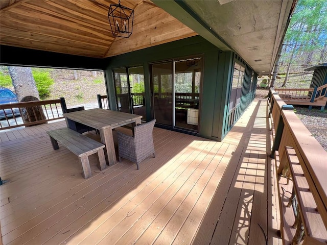 wooden deck featuring outdoor dining space