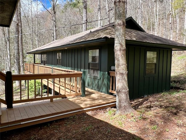 wooden terrace with a wooded view