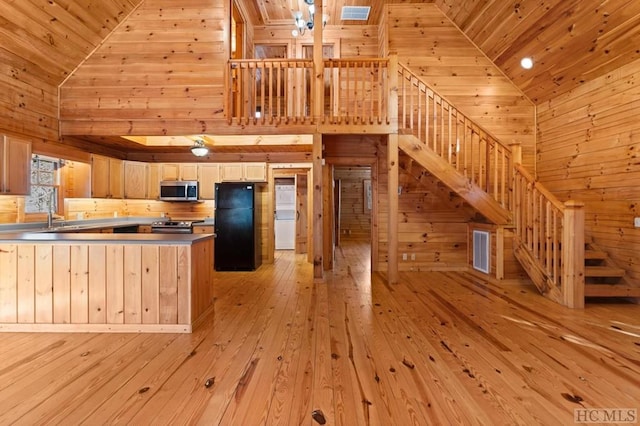 kitchen featuring high vaulted ceiling, wood ceiling, light brown cabinets, and appliances with stainless steel finishes