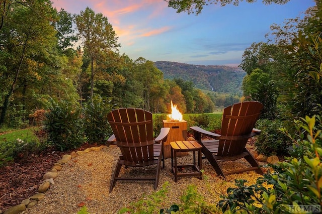 patio terrace at dusk featuring an outdoor fire pit