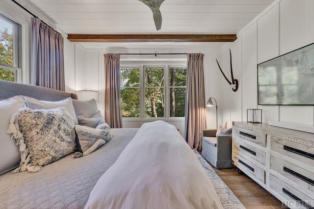 bedroom featuring dark wood-type flooring and beamed ceiling