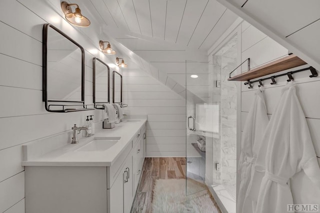 bathroom with vanity, wood ceiling, a shower with shower door, and wood walls