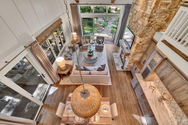 living room with hardwood / wood-style flooring and a high ceiling