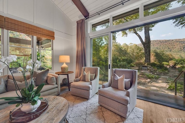 sunroom with vaulted ceiling with beams