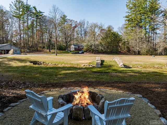 view of yard with a fire pit