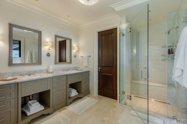 bathroom with vanity, crown molding, and a shower with shower door