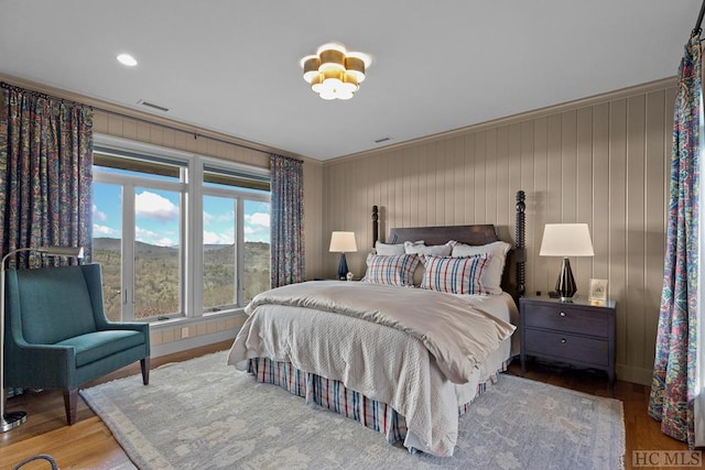 bedroom featuring hardwood / wood-style flooring and ornamental molding