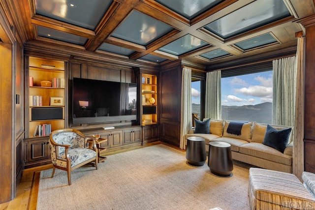 cinema room featuring built in shelves, ornamental molding, coffered ceiling, and wood walls