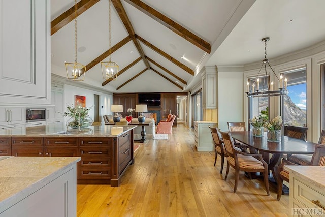 kitchen with light hardwood / wood-style flooring, high vaulted ceiling, a notable chandelier, decorative light fixtures, and beamed ceiling