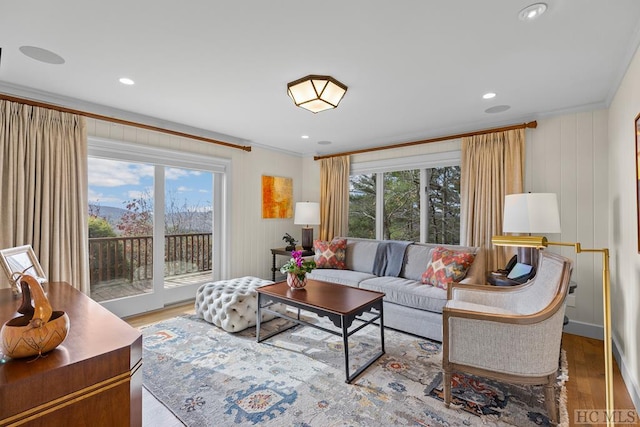 living room with hardwood / wood-style flooring and crown molding