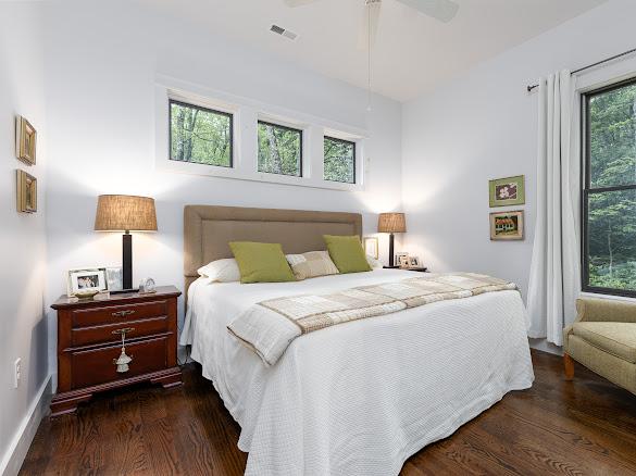 11 Feldspar Ln, Sapphire, NC 28774 - bedroom featuring wood finished floors and ceiling fan