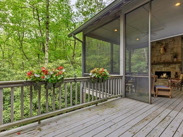 11 Feldspar Ln, Sapphire, NC 28774 - wooden deck featuring a fireplace and a sunroom