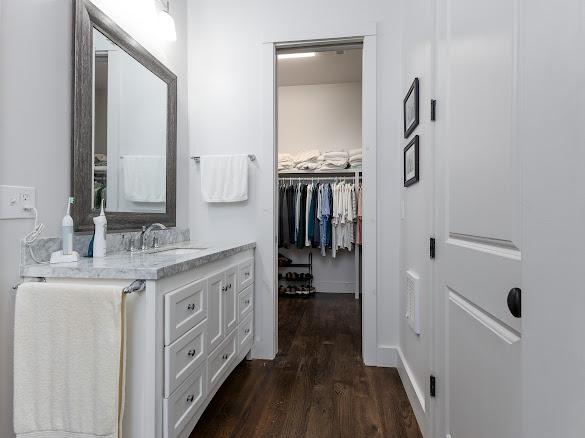 11 Feldspar Ln, Sapphire, NC 28774 - bathroom with vanity, wood finished floors, and a walk in closet