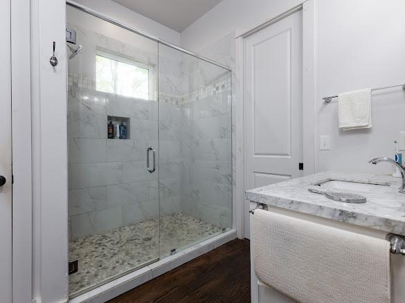 11 Feldspar Ln, Sapphire, NC 28774 - full bath featuring a shower stall, wood finished floors, and vanity