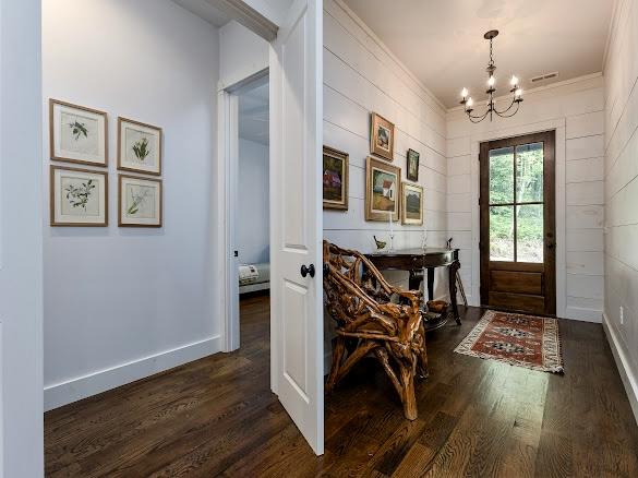 11 Feldspar Ln, Sapphire, NC 28774 - foyer entrance featuring a chandelier, dark wood finished floors, and crown molding