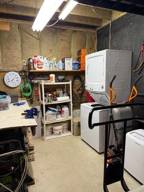 26 S Cumberland Dr, Lake Toxaway, NC 28747 - unfinished basement with stacked washer / drying machine and a workshop area
