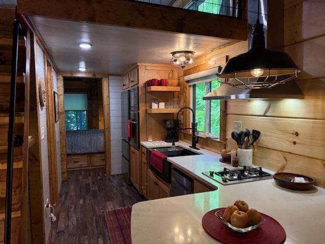 26 S Cumberland Dr, Lake Toxaway, NC 28747 - kitchen featuring a sink, dark wood finished floors, open shelves, stainless steel gas stovetop, and light countertops
