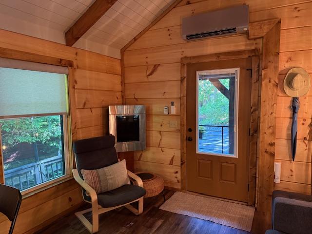 26 S Cumberland Dr, Lake Toxaway, NC 28747 - doorway to outside with a wall mounted AC, wood walls, and wood finished floors