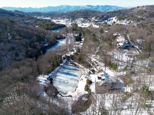 snowy aerial view with a mountain view