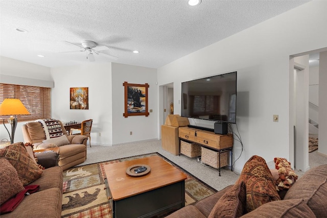 living room featuring ceiling fan, a textured ceiling, and carpet flooring