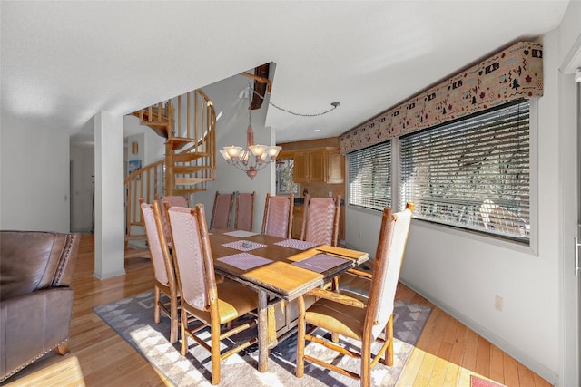 97 Twin Kettle Fls, Glenville, NC 28736 - dining area with stairway, baseboards, a notable chandelier, and light wood finished floors