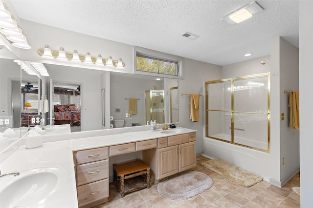 full bathroom with vanity, toilet, enclosed tub / shower combo, and a textured ceiling