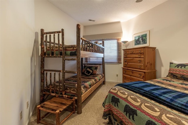 bedroom featuring carpet floors and a textured ceiling