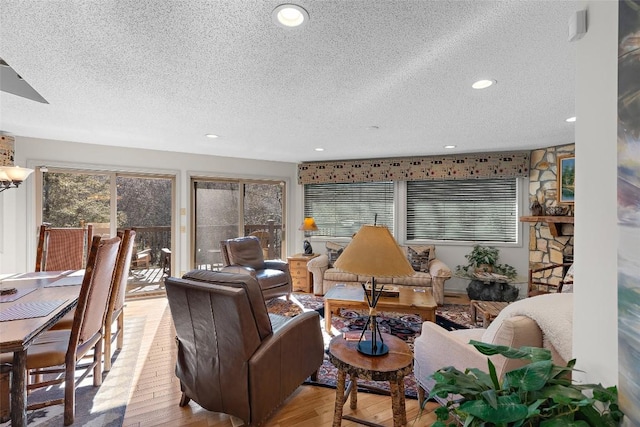 living room featuring light hardwood / wood-style floors and a textured ceiling