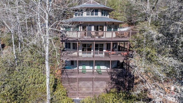 rear view of property featuring a wooden deck