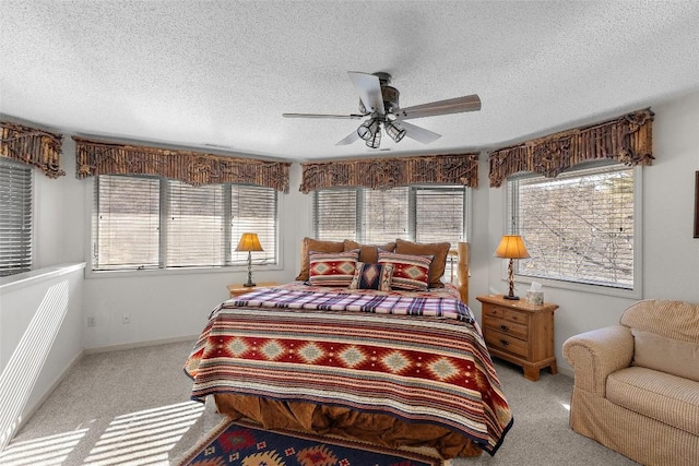 carpeted bedroom featuring multiple windows and a textured ceiling