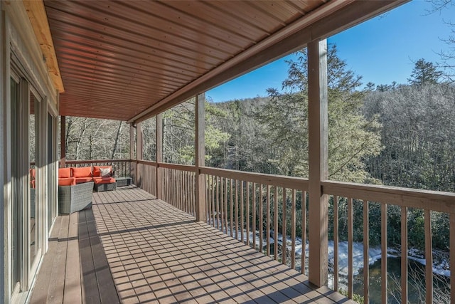 wooden terrace featuring outdoor lounge area