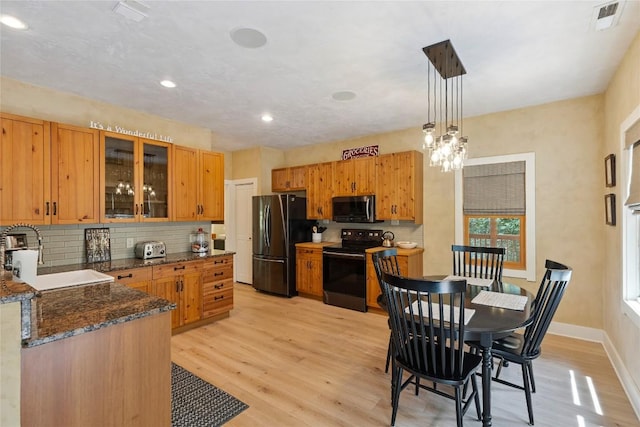 132 Azalea Ct, Sapphire, NC 28774 - kitchen with freestanding refrigerator, electric range, stainless steel microwave, tasteful backsplash, and light wood finished floors