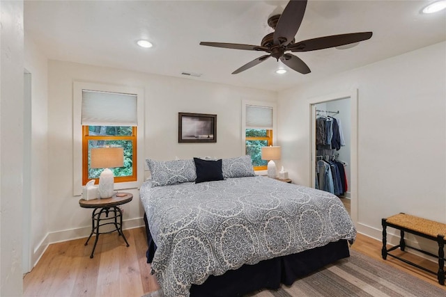 132 Azalea Ct, Sapphire, NC 28774 - bedroom with multiple windows, light wood-style flooring, recessed lighting, a walk in closet, and a closet