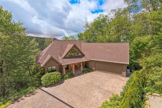 451 Country Club Dr, Highlands, NC 28741 - view of front of house featuring an attached garage, decorative driveway, and a chimney