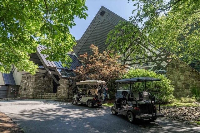 451 Country Club Dr, Highlands, NC 28741 - view of front of home featuring a standing seam roof, stone siding, and a metal roof