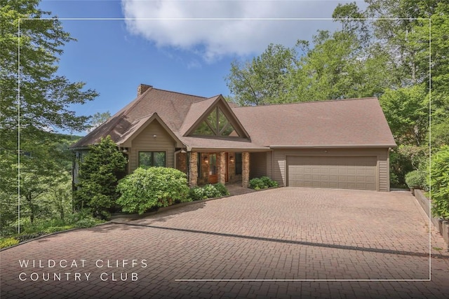 451 Country Club Dr, Highlands, NC 28741 - view of front of home featuring an attached garage, decorative driveway, and a chimney