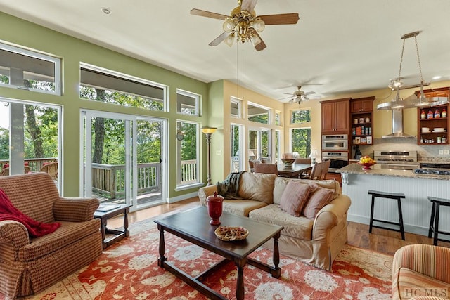 sunroom featuring ceiling fan and a wealth of natural light