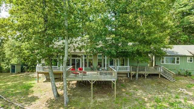 rear view of house featuring a wooden deck