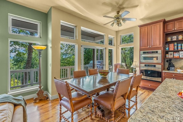 dining area featuring light wood-type flooring and ceiling fan