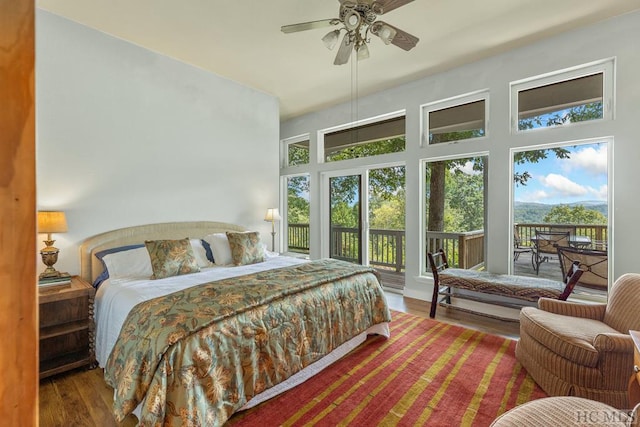 bedroom with hardwood / wood-style floors, ceiling fan, and access to outside