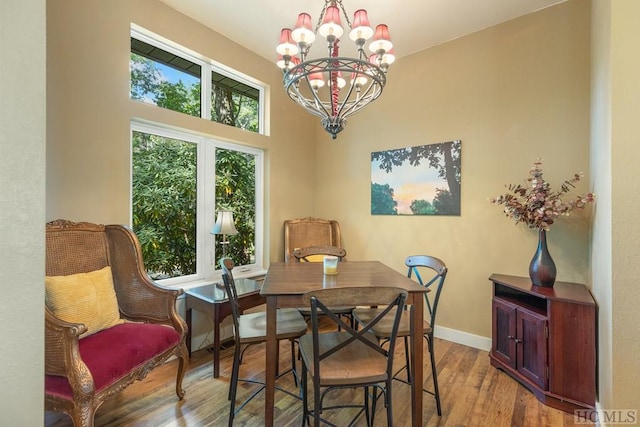 dining space with an inviting chandelier and hardwood / wood-style floors