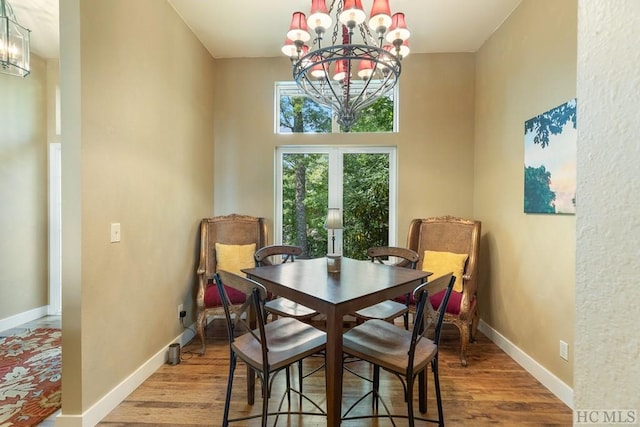 dining space with light wood-type flooring and a chandelier