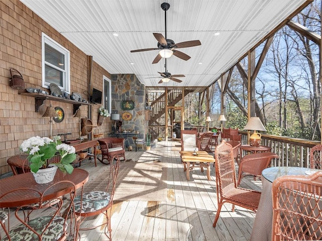 sunroom / solarium featuring a ceiling fan